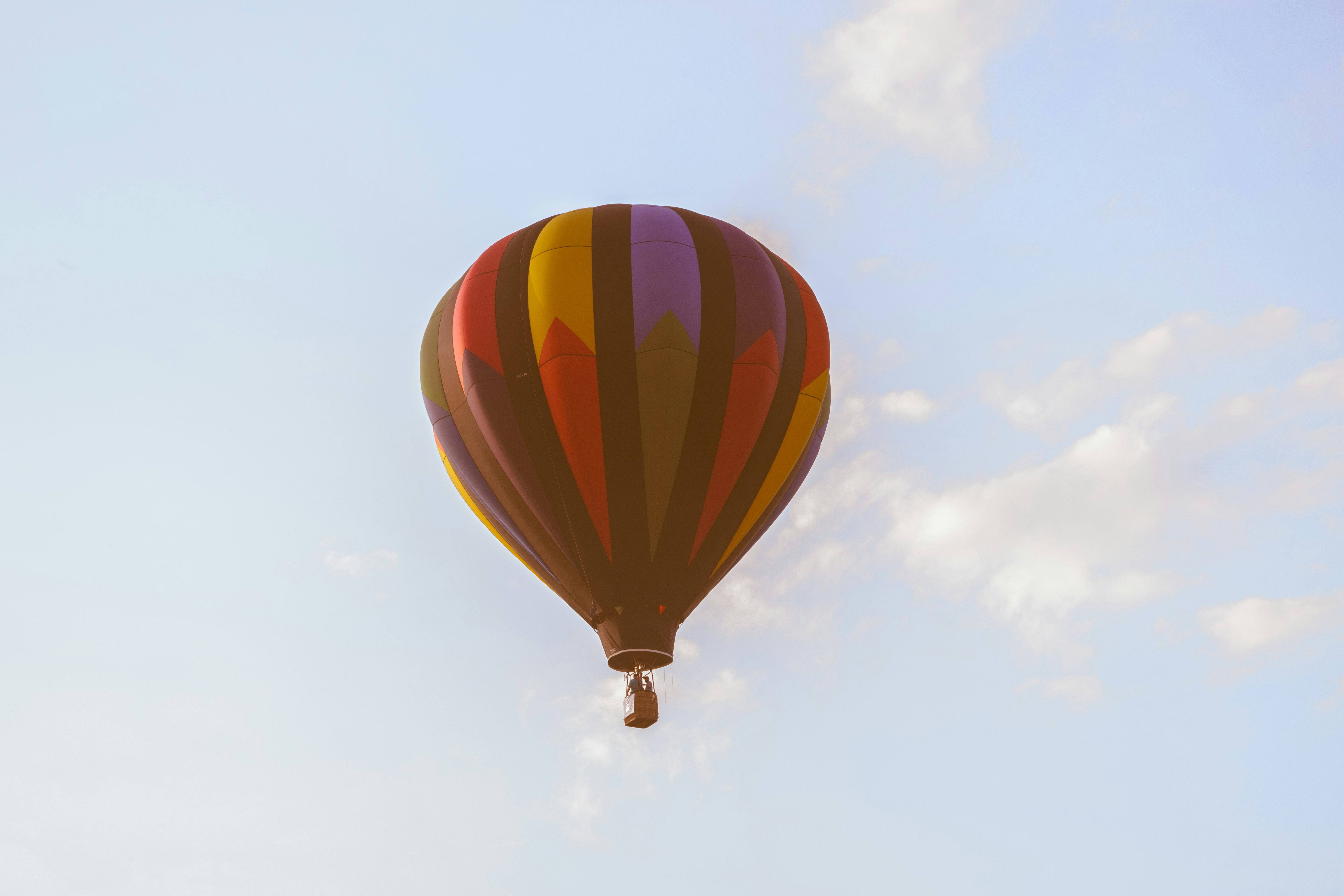 low angle photo of red and black hot air ballon